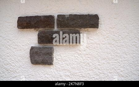 Stone wall with decorative stones and facings Stock Photo