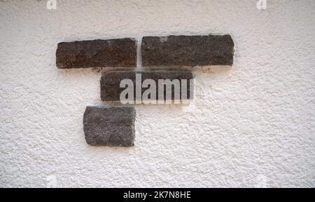 Stone wall with decorative stones and facings Stock Photo