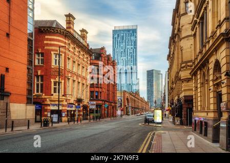 Manchester, United Kingdom - 17 July 2022: Deansgate, a main street in Manchester City Centre, England, view of historical brick houses and the modern Stock Photo