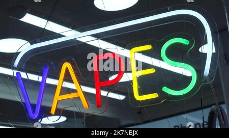 Vapes neon sign at a Vape Shop supplying eCigs, eJuice, supplies, Stock Photo