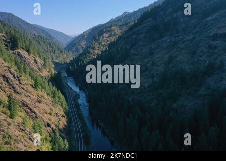 Aerial View of Lochsa River looking upstream with Highway 12 alongside. Selway-Bitterroot Wilderness on the right. Lowell, Idaho, USA Stock Photo