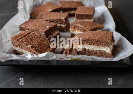 Milk slice cake on a baking tray. Traditional german chocolate sheet cake Stock Photo