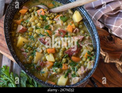 Pea stew with pork meat in a rustic pot. Traditional german cuisine Stock Photo