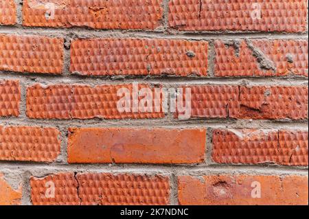 background of red textured relief brick. aged old stone wall or street texture blocks as backdrop closeup. pattern architecture construction design Stock Photo