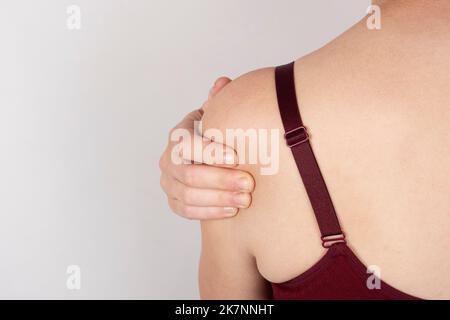 female sore shoulder, woman with shoulder pain. Stock Photo