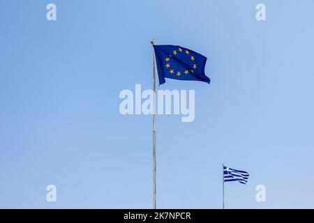 European Union EU and Greece flags is flying in air on blue sky background. Banner, place for text. High quality photo Stock Photo