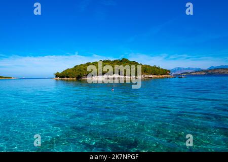 Island in the sea near the coast of Ksamil in Albania Stock Photo