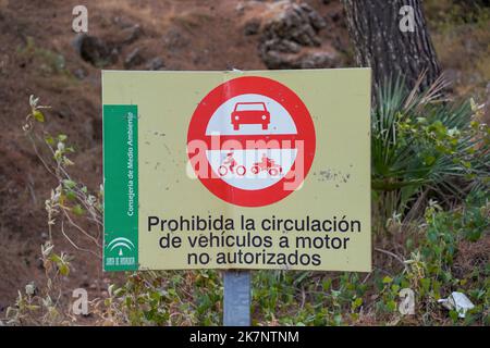 Sign in spanish, no entrance motorised vehicles in mountain forest road. Spain. Stock Photo