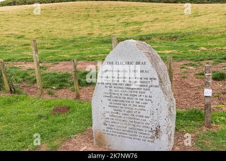 A stone marking Electric Brae or Croy Brae, a road giving an optical illusion of sloping in the wrong direction at Croy, South Ayrshire, Scotland UK Stock Photo