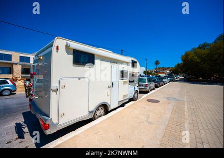 Motorhome  parked in public parking on the street in Paleochora. Campervan or motorhome is parked on the roadside in the Greek village and beach of Pa Stock Photo