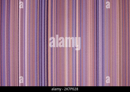 colorful red toned fabric background with soft faded rainbow-colored vertical stripes Stock Photo