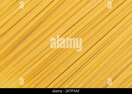 Durum noodles. Close up of raw spaghetti. Full frame fettuccine pasta background Stock Photo