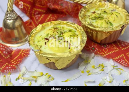 Ras Malai Rossomalai  A sweet dish from Bengal, India made up of balls of paneer soaked in malai sweet cream and garnished with chopped pista Stock Photo