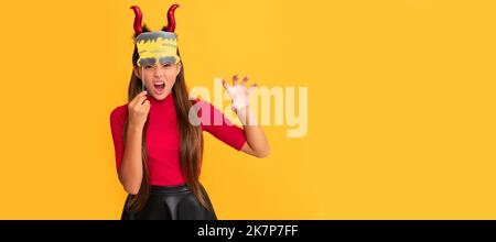 evil child in imp horns with party accessory. Halloween kid girl portrait, horizontal poster. Banner header with copy space. Stock Photo