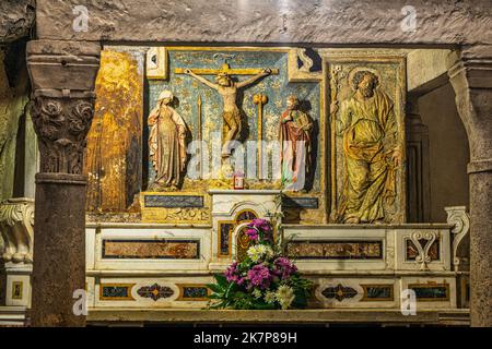One of the altars inside the cave of San Michele Arcangelo. The Sanctuary has been an important pilgrimage site since the early Middle Ages. Puglia Stock Photo