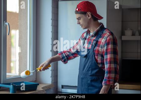Skilled painter getting ready for painting work Stock Photo