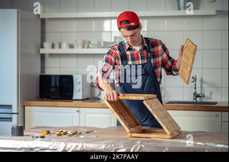 Carpenter involved in making a straw box Stock Photo