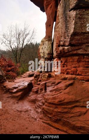 Red rock at the base of Devil's Table, a rock formation in the shape of a large table in the Palatinate Forest of Germany. Stock Photo