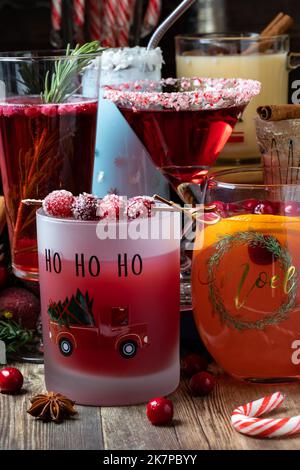 A variety of Christmas cocktails on a wooden table, ready for drinking. Stock Photo