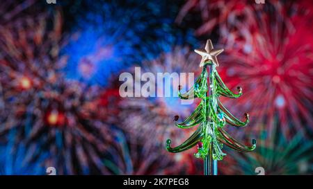 Christmas tree with decorations and fireworks. Merry Christmas and Happy Holidays greeting card, frame, banner. New Year. Winter holiday theme Stock Photo
