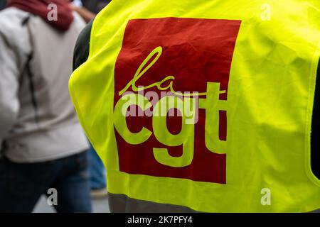 Red logo of the French trade union organization CGT (Confédération Générale du Travail) printed on a yellow vest shot close-up during a demonstration Stock Photo
