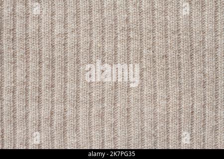 Light beige woolen knitted fabric texture. Macro. Stock Photo
