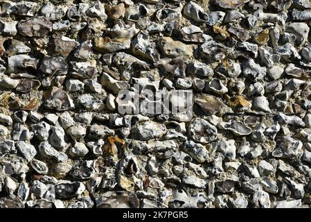 Close up of a wall constructed using flint inside an old English castle. Stock Photo