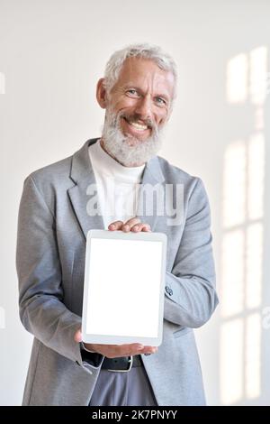 Happy older business man showing tablet mockup screen isolated on white. Stock Photo
