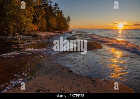 The Hurricane River pours out of the forest and empties into Lake Superior at sunset, Pictured Rocks National Lakeshore, Alger County, Michigan Stock Photo