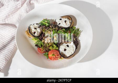 Vegetarian Salad with eggplant and strachatella, Cherry Tomatoes and quinoa on white background for restaurant menu. Stock Photo
