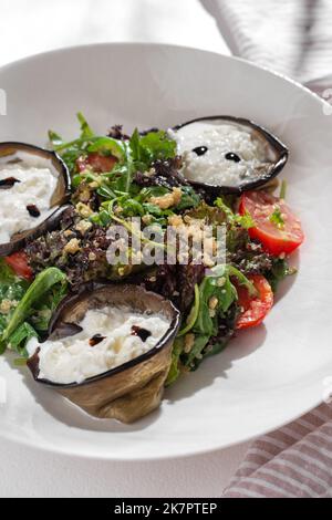 Vegetarian Salad with eggplant and strachatella, Cherry Tomatoes and quinoa on white background for restaurant menu. Stock Photo