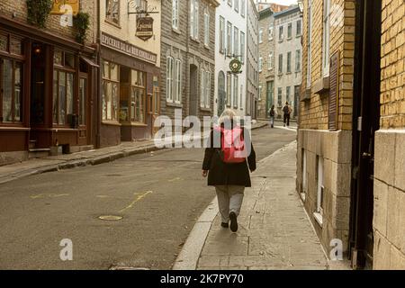 A woman walks in the old district of Quebec city on September 30, 2022. Stock Photo
