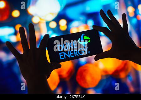 In this photo illustration, the Duke Energy logo is displayed on a smartphone screen. Stock Photo