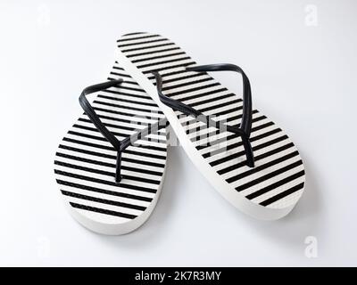 Pair of black and white stripe flip flops isolated on white background ...