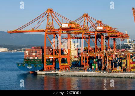Cranes loading shipping containers in the Port of Vancouver - Vancouver, British Columbia, Canada Stock Photo