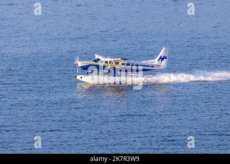 Harbour Air floatplane landing in Vancouver Harbour - Vancouver, British Columbia, Canada Stock Photo