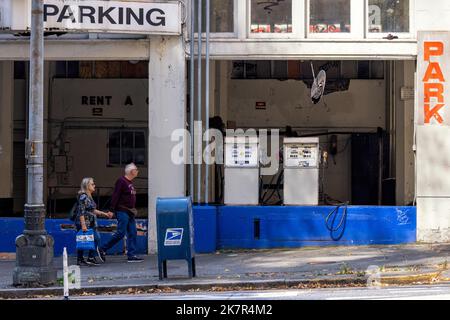 Couple walking by abandoned fuel pumps in parking garage in downtown Seattle, Washington, USA Stock Photo