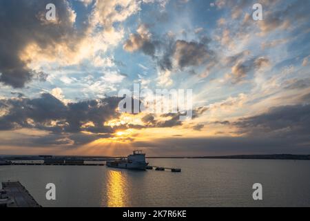 Sun rays through the clouds at sunset Stock Photo