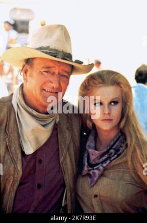 John Wayne & Ann-Margret Film: The Train Robbers (USA 1973) Characters: Lane & Mrs. Lowe  Director: Burt Kennedy 07 February 1973   **WARNING** This Photograph is for editorial use only and is the copyright of BATJAC PRODUCTIONS and/or the Photographer assigned by the Film or Production Company and can only be reproduced by publications in conjunction with the promotion of the above Film. A Mandatory Credit To BATJAC PRODUCTIONS is required. The Photographer should also be credited when known. No commercial use can be granted without written authority from the Film Company. Stock Photo