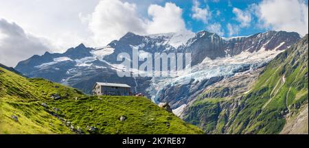 The massif of Grosses Fiescher horn peak and Berghaus Baregg chalet - Switzerland - Grindelwald. Stock Photo