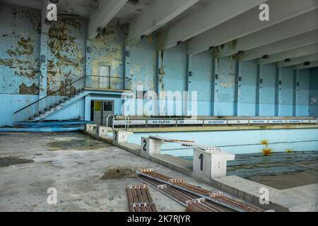 Derelict building indoors with abandoned swimming pool like Chernobyl, Bulgaria Stock Photo