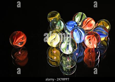 Vintage glass children's marbles on black glass Stock Photo