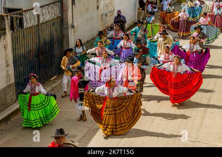 View of the Parade of Delegations to the Guelaguetza in the streets of San Antonino Castillo Velasco near Oaxaca, Mexico. Stock Photo