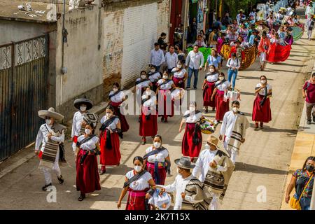 View of the Parade of Delegations to the Guelaguetza in the streets of San Antonino Castillo Velasco near Oaxaca, Mexico. Stock Photo