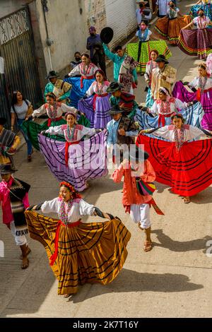 View of the Parade of Delegations to the Guelaguetza in the streets of San Antonino Castillo Velasco near Oaxaca, Mexico. Stock Photo