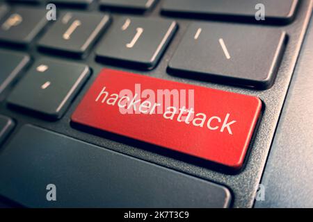 Close-up view on conceptual keyboard - hacker Attack red key on laptop keyboard. blurred background. Stock Photo