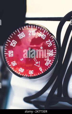 Yacht equipment compass and rope. Vertical photo. Stock Photo