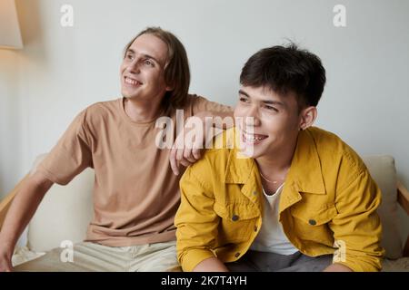Joyful best friends spending time in college dormitory Stock Photo