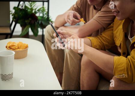 Cropped image of excited young people using online dating application Stock Photo