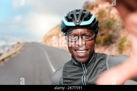 Cycling, portrait and selfie with man in a road along a mountain in South Africa, happy, relax and excited. Fitness, training and face of cyclist Stock Photo